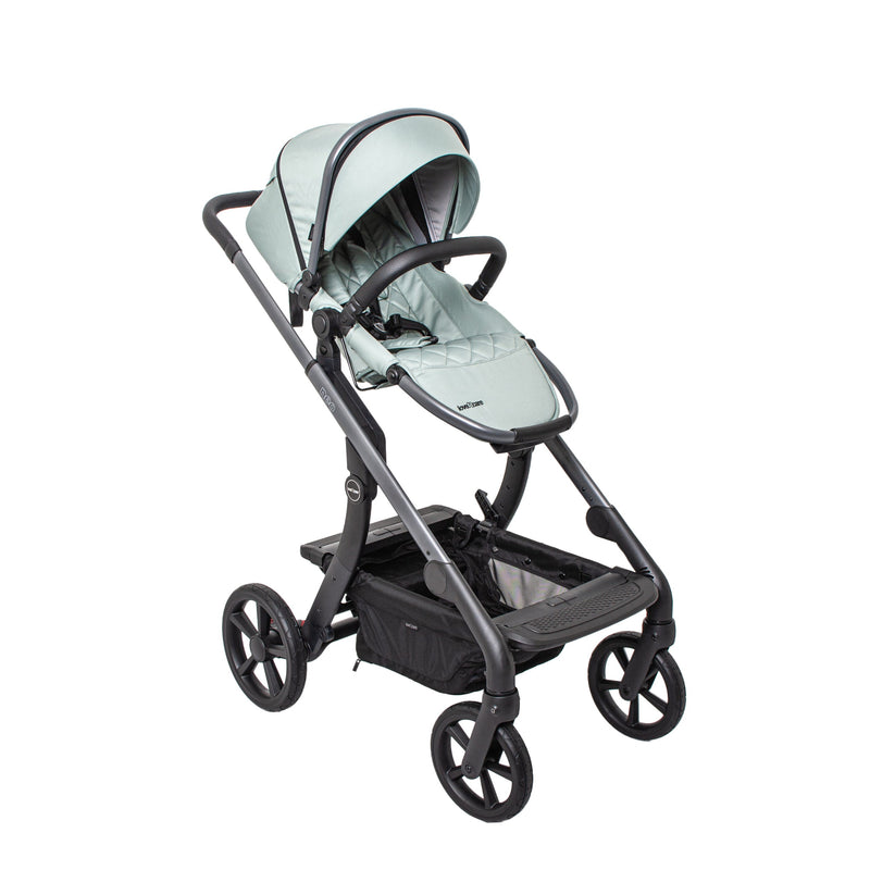 An all-terrain stroller in sage, folded out and ready for a walk