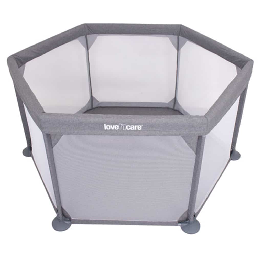 A portable play yard set up in a living room, giving a crawling baby a safe space